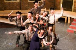 Graduation Day. Dani Stoller as Flora (center), surrounded by the ensemble. Front row, from left: Sam Edgerly, Sherry Berg, Kelsey Meiklejohn. Middle 