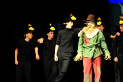 The Scarecrow (Adam Uslan) is taunted by the five crows (Joshua Yu, Wyatt Oring, Mike Neild, Burak Demir and Daniel Hamburg)